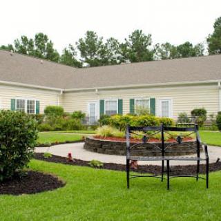 A well-maintained house with a landscaped garden and patio area.