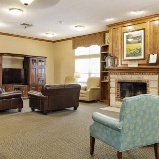 A cozy living room with comfortable seating and a fireplace.