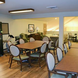 A cozy dining and lounge area with wooden flooring and comfortable seating.