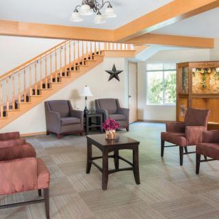 A hotel lobby featuring comfortable seating and a staircase.