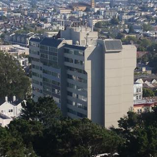 A panoramic view of a modern building amidst a sprawling urban landscape.