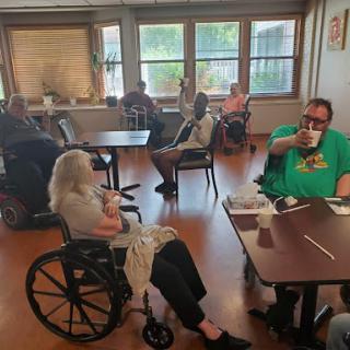 Residents enjoying their time together in a common area of a care facility.