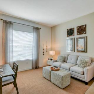 A cozy living room with a sofa, table, and wall artwork.