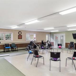 A spacious community room with chairs arranged in a circle, ideal for meetings or group activities.