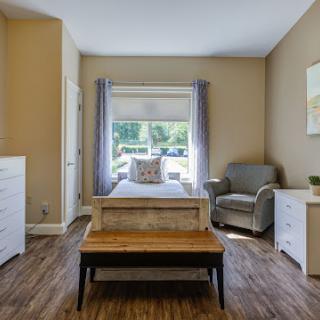 A cozy and well-lit bedroom featuring modern furniture and a welcoming atmosphere.