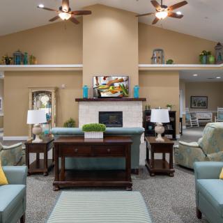 A well-decorated living room featuring a cozy arrangement with sofas and a fireplace.