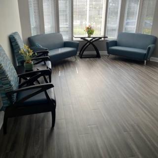 A bright waiting room with comfortable seating and a large window.