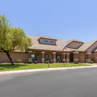 A suburban building with a neatly landscaped exterior and clear blue sky.