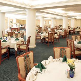 Elegant dining area set up with neatly arranged tables and chairs.