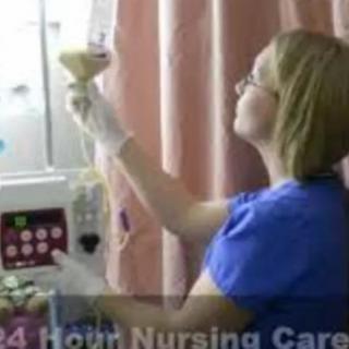 A nurse adjusts an IV drip in a healthcare setting.