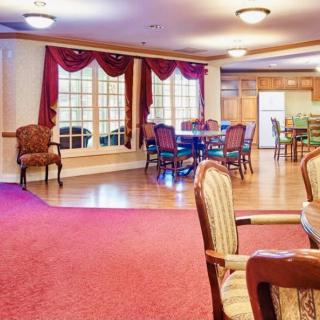 A spacious dining area with elegant furniture and large windows.