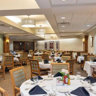 An elegantly arranged dining room with multiple tables set for guests.