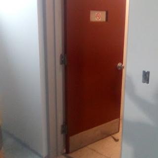 A wooden door leading to an unknown room.