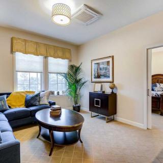 A cozy and well-decorated living room featuring a comfortable sofa, a round coffee table, and stylish decor.