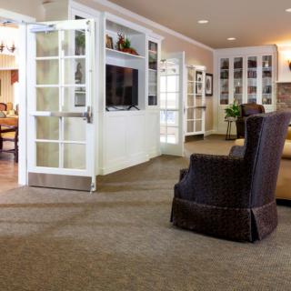 A cozy living room with comfortable seating, a television, and built-in bookshelves.
