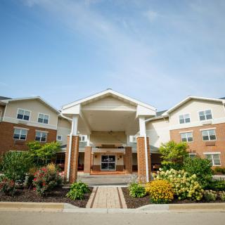A well-maintained residential building with a welcoming entrance and landscaped surroundings.