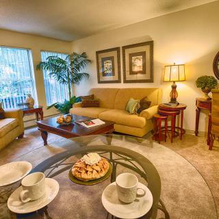 A cozy living room with comfortable seating, warm lighting, and elegant decor.