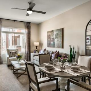 A beautifully decorated living and dining area featuring modern furnishings and a cozy atmosphere.