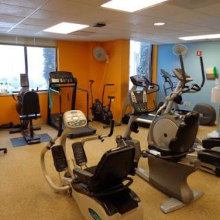 A well-equipped fitness room featuring various exercise machines for a complete workout experience.