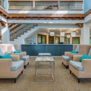 A modern lobby featuring comfortable seating and a stylish reception area.