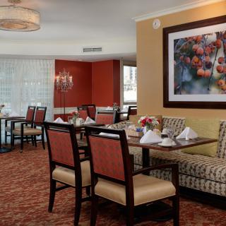 A cozy dining room with elegant furnishings and artwork on the wall.