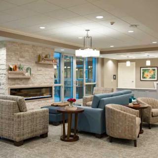 A modern lobby with comfortable seating and a cozy fireplace.