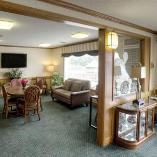 A well-lit lobby with comfortable seating and decor.