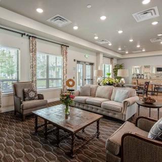 A cozy living room with comfortable seating and large windows.