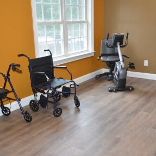 A room featuring mobility aids and exercise equipment by the window.