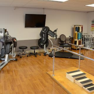 A well-equipped gym space designed for fitness and rehabilitation exercises.