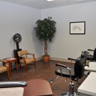 Cozy hair salon with waiting area and decor.