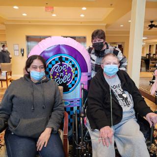 A heartfelt moment shared among family members at an assisted living facility.