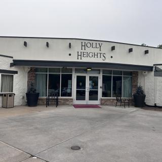 Exterior view of a commercial building with a sign reading 'Holly Heights'.