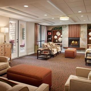A modern and cozy lobby featuring comfortable seating and a fireplace.