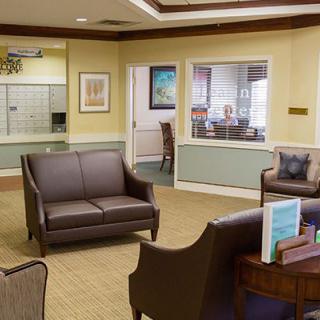 A well-furnished waiting room with sofas and chairs arranged neatly.
