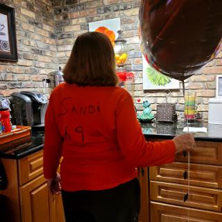 Celebrating a special occasion in a cozy kitchen setting.