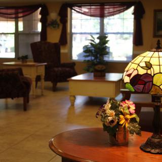 A cozy lobby interior with a decorative lamp and comfortable seating.