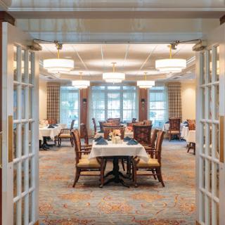 A beautifully designed dining room with elegant furnishings and warm lighting, inviting guests to enjoy their meals.