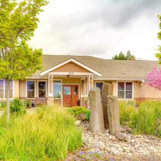 A charming house surrounded by lush greenery and a well-maintained garden.