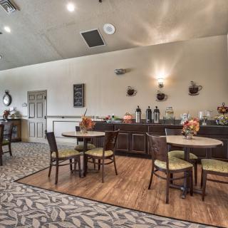 A cozy dining area with a buffet setup and stylish decor.