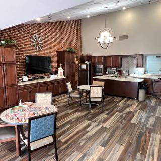 A modern kitchen and dining area with wood flooring and stylish furniture.