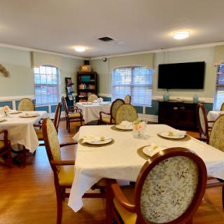 A cozy dining area set up with tables and chairs, ready for a meal.