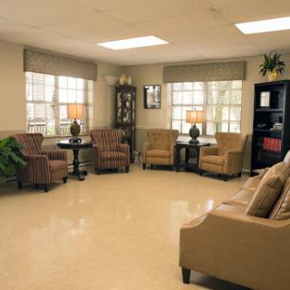 A cozy living room setup featuring comfortable seating, natural light, and decorative elements.