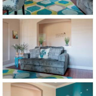 A cozy living room featuring a modern sofa and colorful geometric rug.