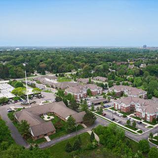 Aerial view of a suburban residential area with green surroundings.