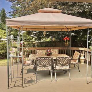 A cozy outdoor setup with a gazebo covering a patio table and chairs.