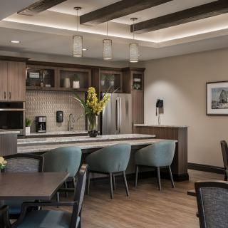 A modern kitchen and dining area with sleek furniture and elegant lighting.