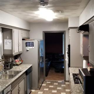 A modern kitchen with stainless steel appliances and granite countertops.