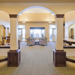 A spacious lobby with elegant archways and a cozy seating area.