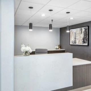 A modern office reception area with a sleek design and elegant lighting.
